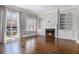 Bright living room with a fireplace, built-in shelving, hardwood floors, and sliding glass doors to outdoor area at 1836 Preserve Way, Brookhaven, GA 30341