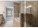 Main bathroom featuring a soaking tub with tile surround and frameless glass shower at 1836 Preserve Way, Brookhaven, GA 30341