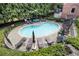 Inviting community pool surrounded by lounge chairs, lush greenery, and shaded seating areas at 1836 Preserve Way, Brookhaven, GA 30341
