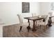 Elegant dining room with wood floors, a large table, and upholstered chairs at 2308 Argento Cir, Dacula, GA 30019