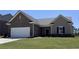 Charming single-story home with a brick facade, attached garage, and well-manicured lawn at 2308 Argento Cir, Dacula, GA 30019