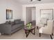 Cozy living room with comfortable seating, neutral decor, and a view into the hallway at 2308 Argento Cir, Dacula, GA 30019