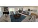 Spacious living room with an open floor plan, stylish furnishings, and natural light at 2308 Argento Cir, Dacula, GA 30019