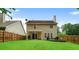 Well-manicured backyard featuring a spacious lawn, wooden fence, and the home's exterior at 306 Overbend Sw Lndg, Marietta, GA 30008