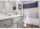 Bright bathroom with dual vanity, walk-in shower, and modern blue and white accents at 306 Overbend Sw Lndg, Marietta, GA 30008
