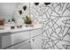 Stylish bathroom vanity with geometric wallpaper, plants, and modern fixtures at 306 Overbend Sw Lndg, Marietta, GA 30008