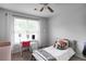 Bright bedroom featuring a large window, comfortable bed, and a work desk at 306 Overbend Sw Lndg, Marietta, GA 30008