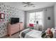 Cozy bedroom featuring floral wallpaper, a comfortable bed, and a bright window at 306 Overbend Sw Lndg, Marietta, GA 30008