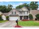 Charming two-story home with a front porch and a well-manicured lawn with a flower bed at 306 Overbend Sw Lndg, Marietta, GA 30008