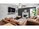 Cozy living room with a decorative fireplace, large tv, and comfortable brown leather sofas at 306 Overbend Sw Lndg, Marietta, GA 30008