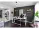 Home office features a dark accent wall with floating shelves, desk and modern pendant lighting at 306 Overbend Sw Lndg, Marietta, GA 30008