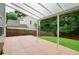 View of the backyard patio with covered awning and view of the green lawn and wooden fence at 306 Overbend Sw Lndg, Marietta, GA 30008
