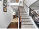 View of the carpeted staircase with modern railing and a view into the living room at 306 Overbend Sw Lndg, Marietta, GA 30008