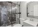 Modern bathroom featuring a glass-enclosed shower with stylish marble tiling and a sleek vanity with a mirror at 397 Lovejoy Cir, Powder Springs, GA 30127