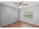 This stylish bedroom has a decorative wall design, ceiling fan, and a bright window at 397 Lovejoy Cir, Powder Springs, GA 30127