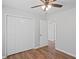 The bedroom has a spacious closet and an open doorway to another room, all with wood-look floors at 397 Lovejoy Cir, Powder Springs, GA 30127