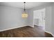 Bright dining room showcasing hardwood floors and pendant lighting, offering comfort and charm at 397 Lovejoy Cir, Powder Springs, GA 30127