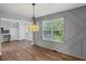 Elegant dining room features custom wall design, hardwood floors and pendant lighting, offering comfort at 397 Lovejoy Cir, Powder Springs, GA 30127