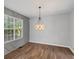 Bright dining room features custom wall design, hardwood floors and pendant lighting, offering comfort at 397 Lovejoy Cir, Powder Springs, GA 30127