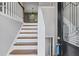 Welcoming foyer with hardwood stairs, decorative molding, and a stylish front door with glass at 397 Lovejoy Cir, Powder Springs, GA 30127