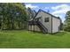 View from back yard showing house's rear elevation, deck, and yard at 397 Lovejoy Cir, Powder Springs, GA 30127