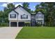 Charming two-story home featuring a two-car garage, manicured lawn and a traditional design at 397 Lovejoy Cir, Powder Springs, GA 30127