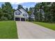 Traditional two-story home with a two-car garage and well-manicured lawn at 397 Lovejoy Cir, Powder Springs, GA 30127