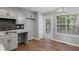 Bright eat-in kitchen offers gray cabinets, updated backsplash, and outdoor access at 397 Lovejoy Cir, Powder Springs, GA 30127