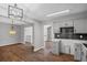 Open floor plan with updated kitchen featuring gray cabinets and modern lighting at 397 Lovejoy Cir, Powder Springs, GA 30127