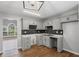 Bright eat-in kitchen featuring gray cabinets, updated backsplash, and natural light at 397 Lovejoy Cir, Powder Springs, GA 30127