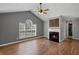 Cozy living room featuring vaulted ceilings, a fireplace with wooden mantel and hardwood flooring at 397 Lovejoy Cir, Powder Springs, GA 30127