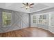 Spacious main bedroom features wood-look floors, tray ceilings, and modern wall accents at 397 Lovejoy Cir, Powder Springs, GA 30127