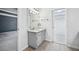 Cozy bathroom with gray vanity, white sink, and views into the carpeted bedroom and walk-in closet at 5427 Trentham Dr, Atlanta, GA 30338