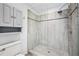 Elegant bathroom featuring a gray shower stall with glass door, a shower head, and built in shelving at 5427 Trentham Dr, Atlanta, GA 30338
