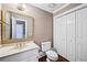 Cozy half-bathroom that features neutral walls, tiled floors, and a stylish vanity at 5427 Trentham Dr, Atlanta, GA 30338