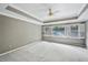 Neutral bedroom with ceiling fan, tray ceiling, and plantation shutters at 5427 Trentham Dr, Atlanta, GA 30338