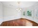 Dining room boasting chair rail, a bay window with a view, and hardwood floors at 5427 Trentham Dr, Atlanta, GA 30338