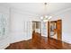 Formal dining room showing access to kitchen and hallway, natural light and hardwood floors at 5427 Trentham Dr, Atlanta, GA 30338
