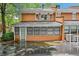 Rear exterior view of the house with a sunroom and brick facade at 5427 Trentham Dr, Atlanta, GA 30338