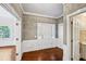 Elegant foyer with hardwood floors, white trim, and access to multiple rooms, including a bathroom at 5427 Trentham Dr, Atlanta, GA 30338
