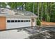 View of the attached garage with a white garage door and a driveway at 5427 Trentham Dr, Atlanta, GA 30338