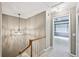 Upstairs hallway with a chandelier and views into the primary bedroom at 5427 Trentham Dr, Atlanta, GA 30338