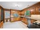 Traditional kitchen featuring wood cabinets, granite countertops, and stainless steel appliances at 5427 Trentham Dr, Atlanta, GA 30338
