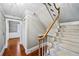 Carpeted staircase with wood railing and a view to the lower level of the home at 5427 Trentham Dr, Atlanta, GA 30338