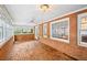The sunroom features brick walls, brick flooring, lots of windows, and a ceiling fan at 5427 Trentham Dr, Atlanta, GA 30338
