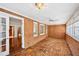 The sunroom features brick walls, brick flooring, lots of windows, and a ceiling fan at 5427 Trentham Dr, Atlanta, GA 30338