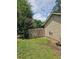 Side yard showcases wooden fence and mature trees, offering privacy at 616 Burnt Creek Nw Way, Lilburn, GA 30047