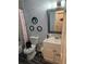Main bathroom features tiled floor, vanity with sink, toilet, and shower at 616 Burnt Creek Nw Way, Lilburn, GA 30047