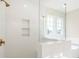 Shower stall showcasing glass divider, a rain shower head, and built in shelving at 164 Palm St, Holly Springs, GA 30188