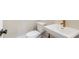 Stylish powder room featuring a modern sink with gold faucet at 164 Palm St, Holly Springs, GA 30188